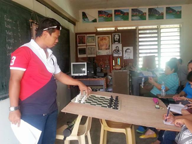 Mr. Melvin Sabio shows how to play chess.